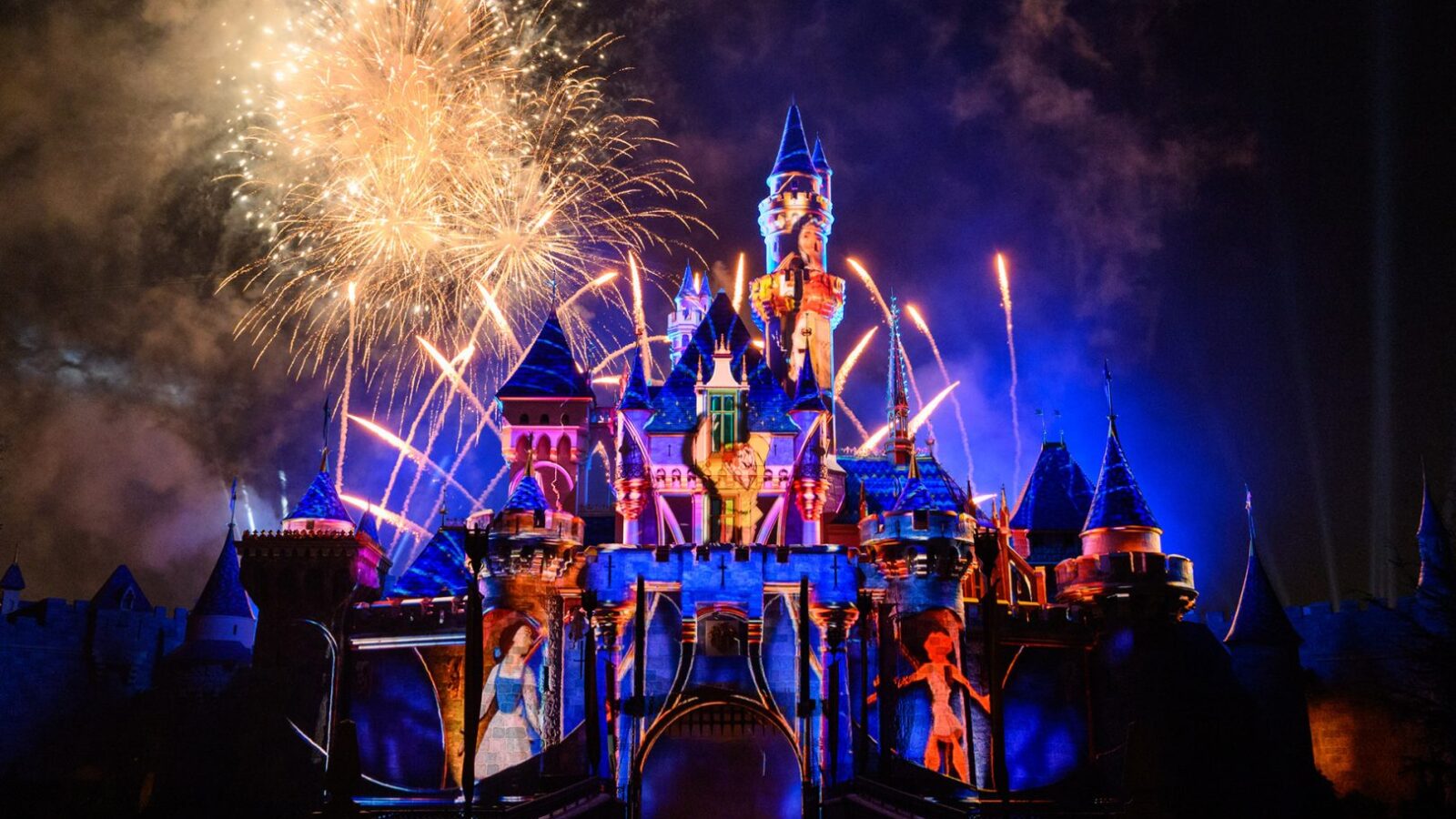 Vista del castillo de Disneyland decorado para el 70º aniversario, con fuegos artificiales iluminando el cielo nocturno. Foto: Disneyland Resort / Disney Parks Blog