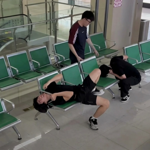 Personal de seguridad debió intervenir para auxiliar a los dos amigos atrapados en bancas de hospital en China. Foto: Captura depantalla.